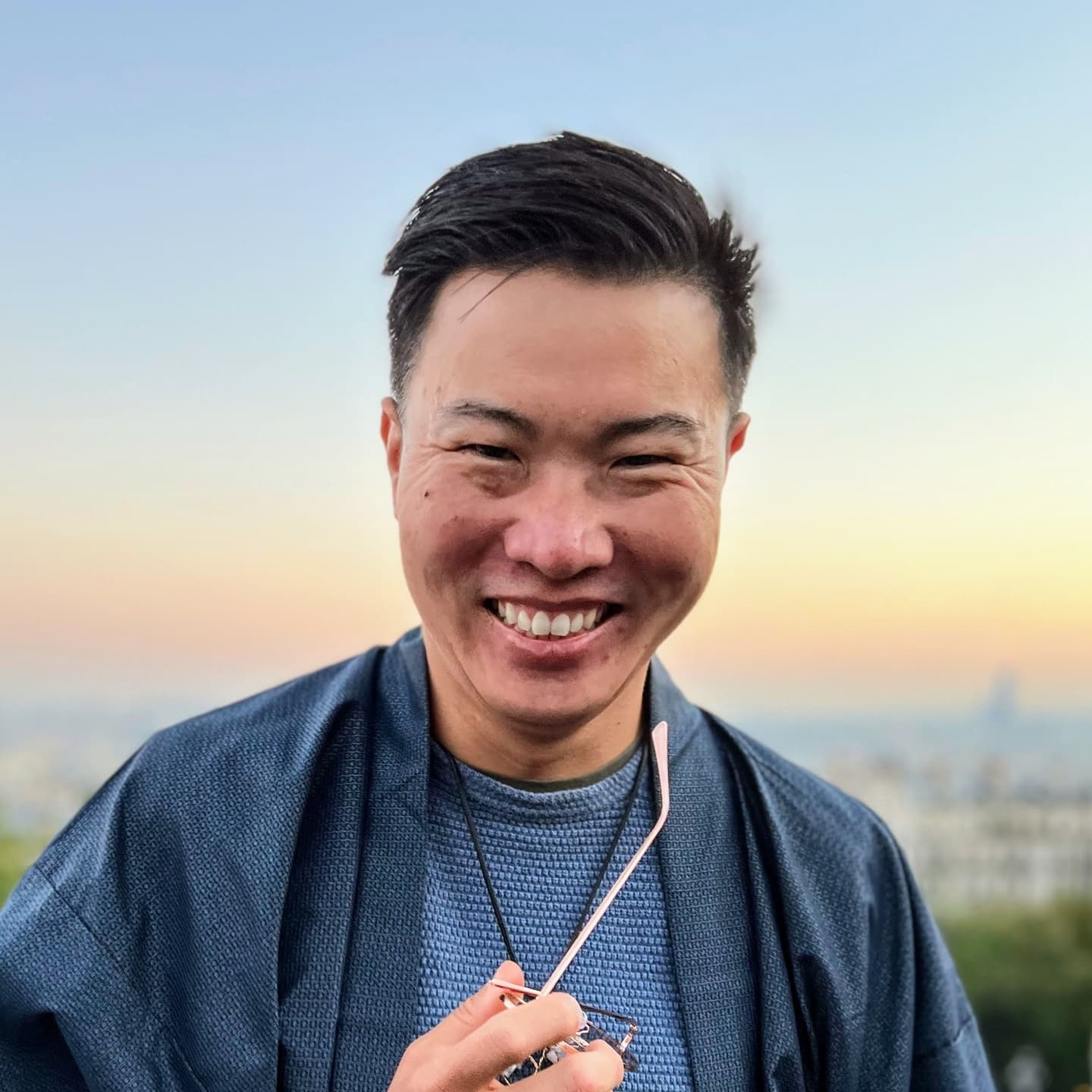 Austin Mao smiling outdoors at sunset
